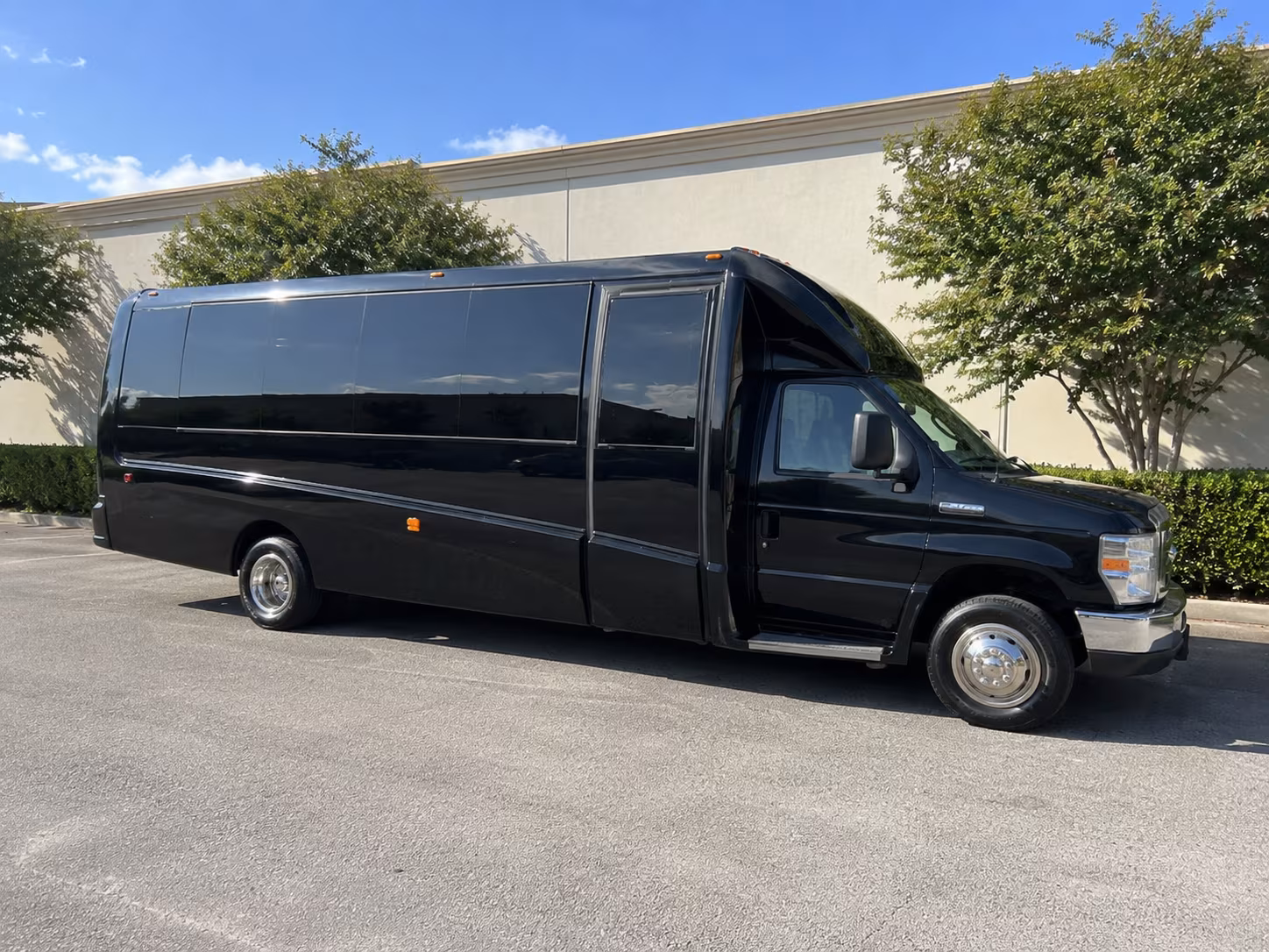 Group beside a Mercedes Sprinter limo in Salinas